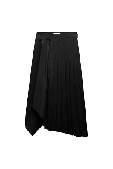 Black pleated skirt with a smooth crossover front panel, button detail at the waist and an asymmetric hem against a white background.