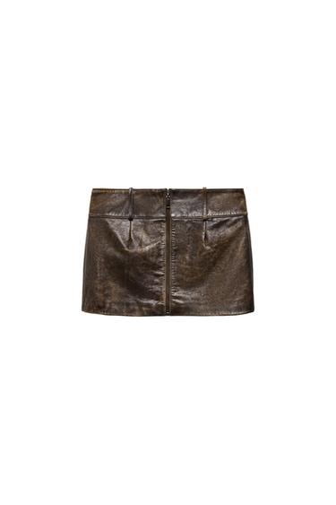 Front view of a short brown skirt with a central zip and belt loops at the waist.