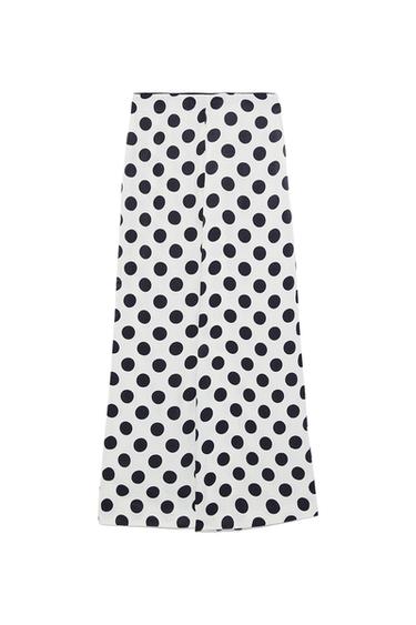 Front view of a white skirt with a large black polka dot print.