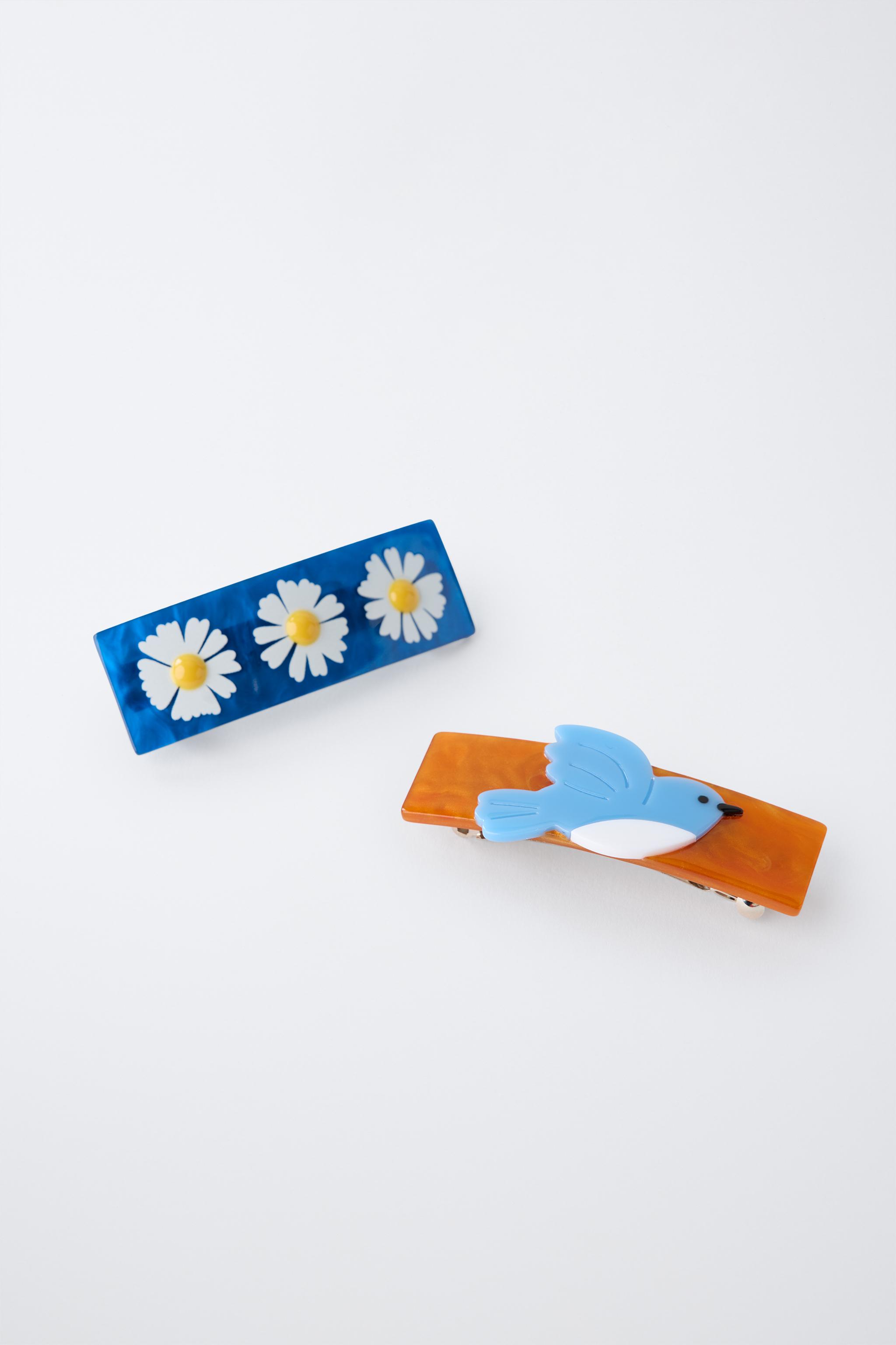 LOT DE DEUX BARRETTES À FLEURS ET OISEAU