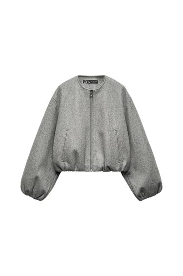 Front view of a grey jacket with zip and side pockets.