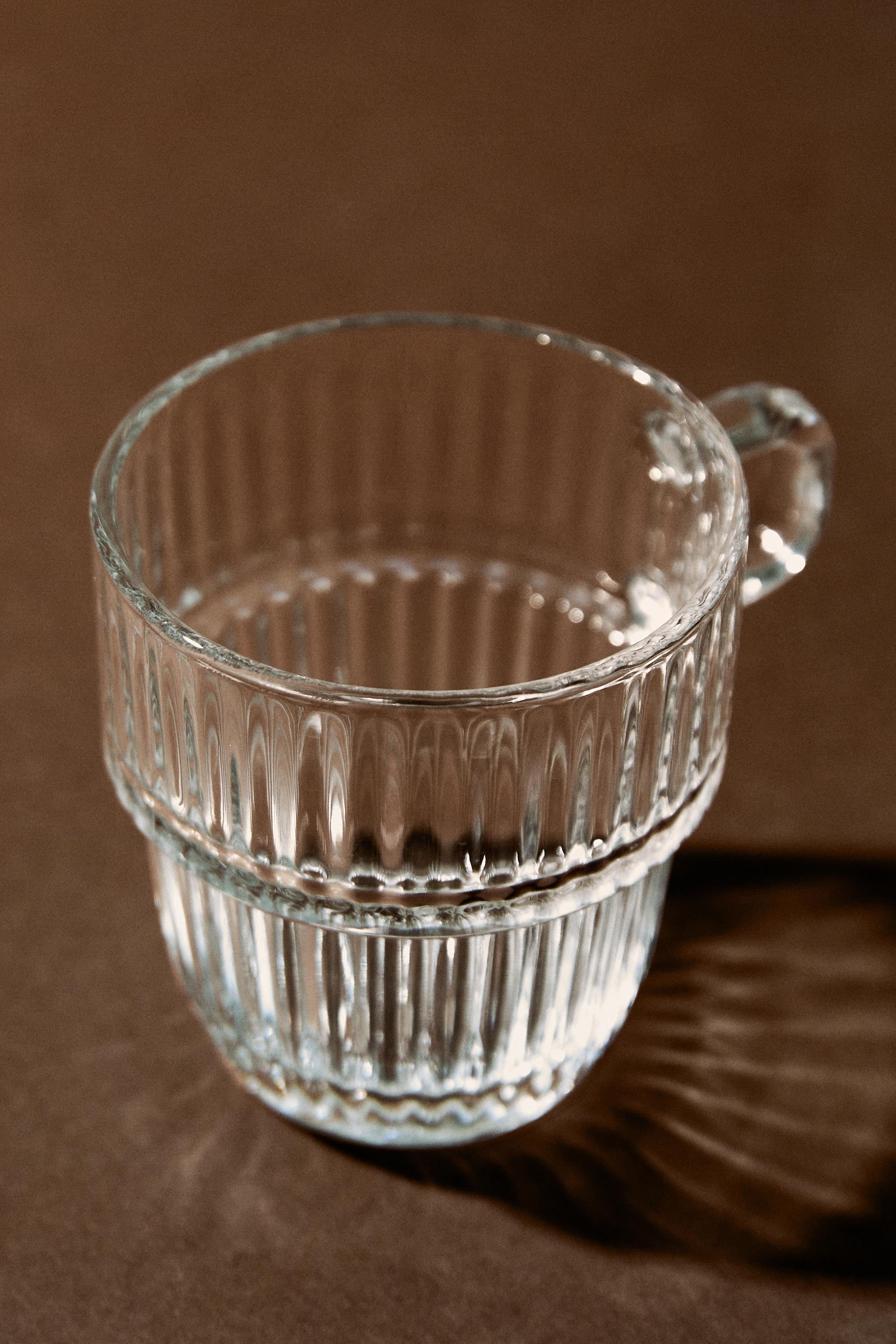 GLASS CUP WITH RAISED DESIGN