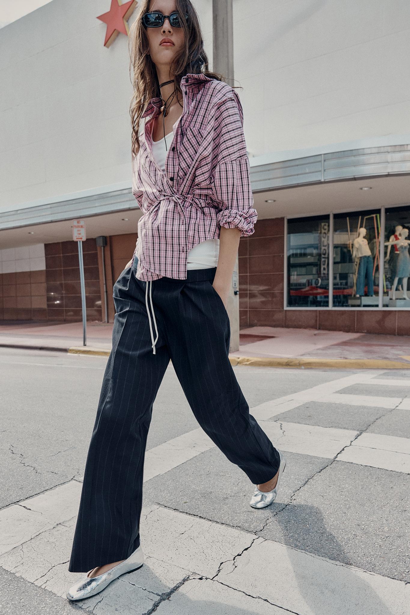 Striped wide-leg pants set with an adjustable double waist and front pockets, a plaid shirt, and silver shoes.