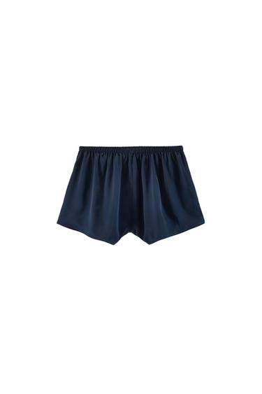 Front view of navy blue shorts with an elasticated waistband and a low rise.