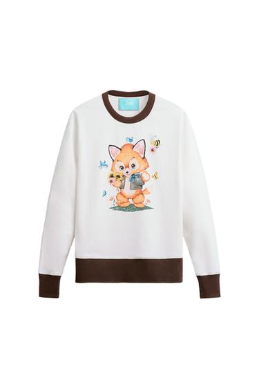 Brown cuff and hem. White sweatshirt with collar and cuffs. Print of a fox wearing a vest with sunflowers. ZARA label at the collar.