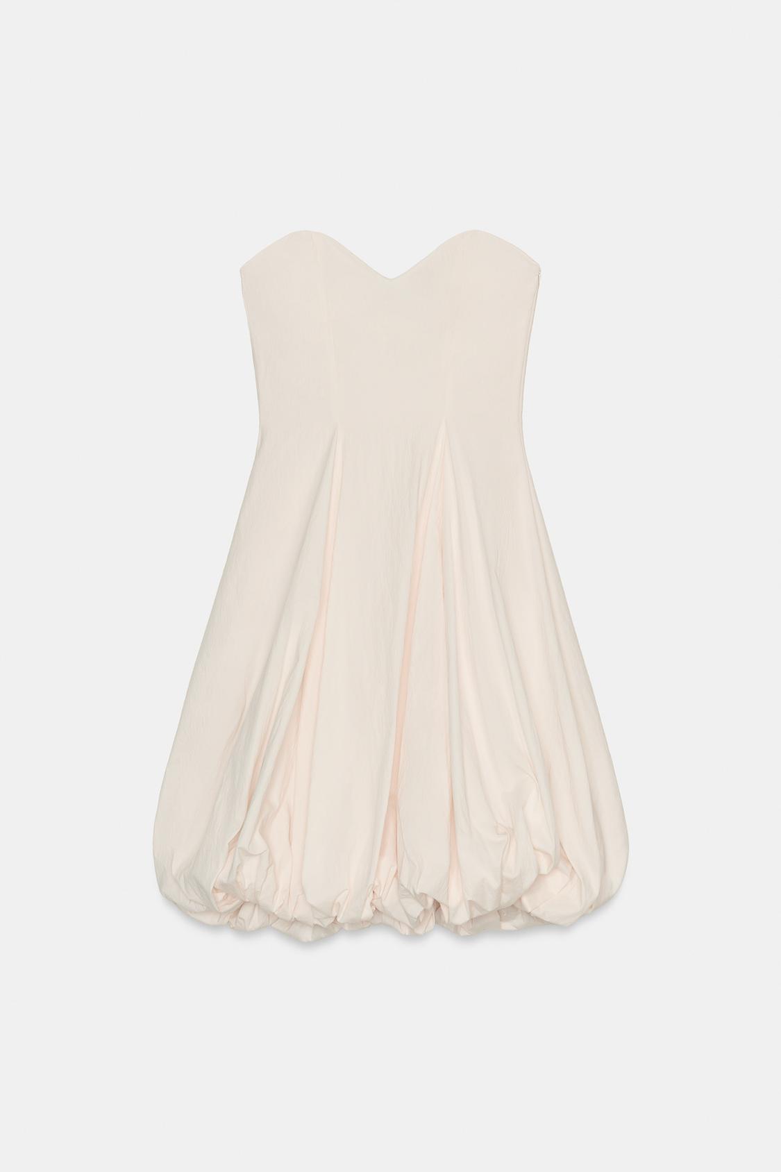 Front view of a blush pink, strapless dress with a sweetheart neckline and bubble hem. Concealed side zip.