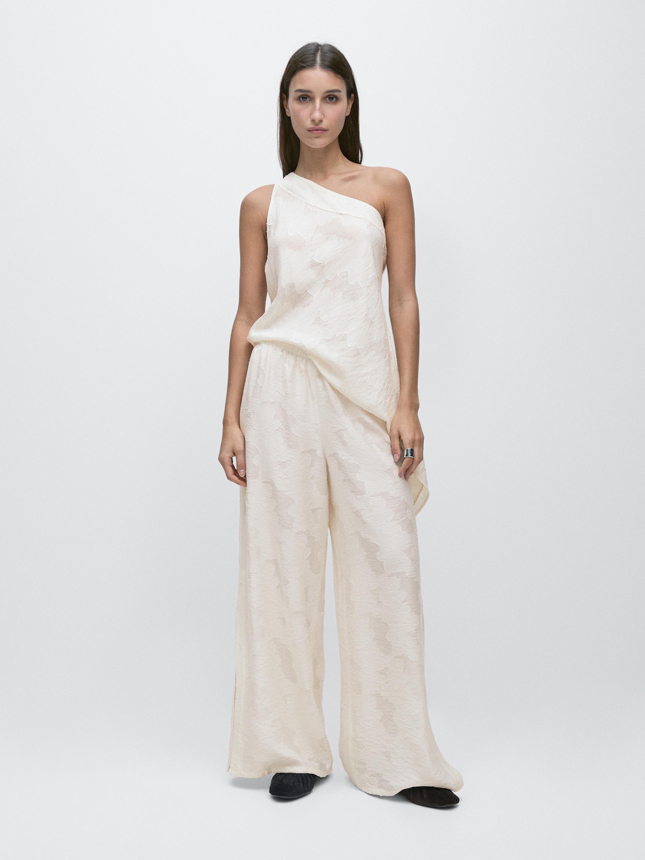 Flowing stretch trousers with fabric detail