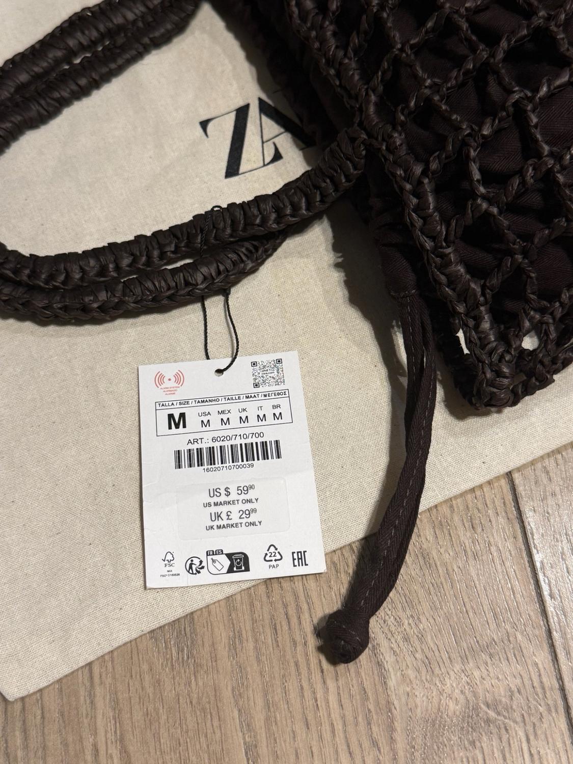 Brown braided bag detail on ZA bag. Label: SIZE M ART.: 6020/710/700 US $ 59.90 US MARKET ONLY UK £ 29.99 UK MARKET ONLY.