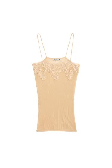 Front view of a light pink tank top with lace on the neckline and ribbed fabric.