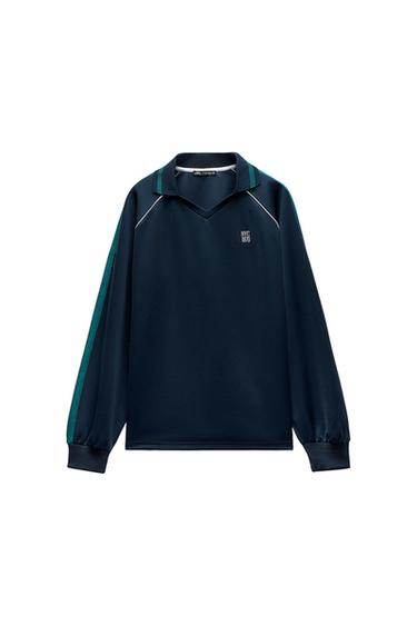 Navy blue V-neck sweatshirt with green details and "NYC 1970" text on the chest. Long sleeves with elastic cuffs.