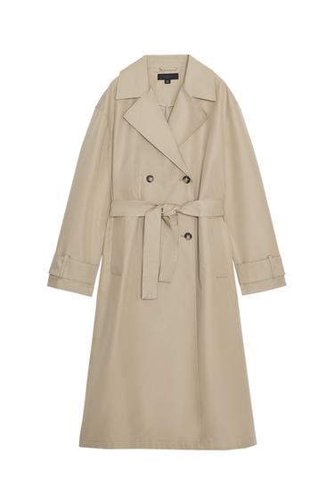 Front view of a toasted long trench coat with a lapel collar, long sleeves, jetted front pockets, and a matching belt.