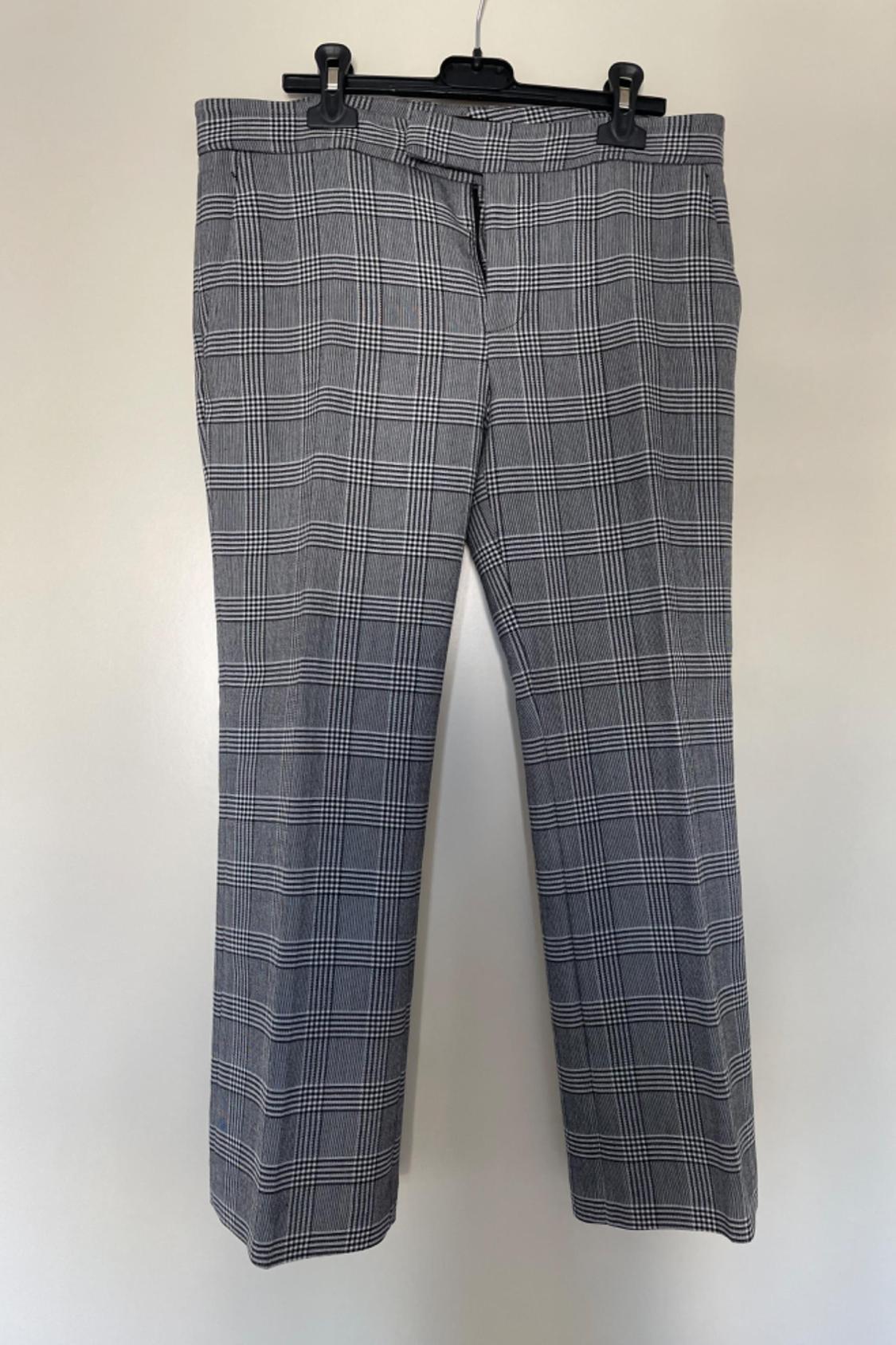 Front view of grey checked trousers with a waistband and front fastening.