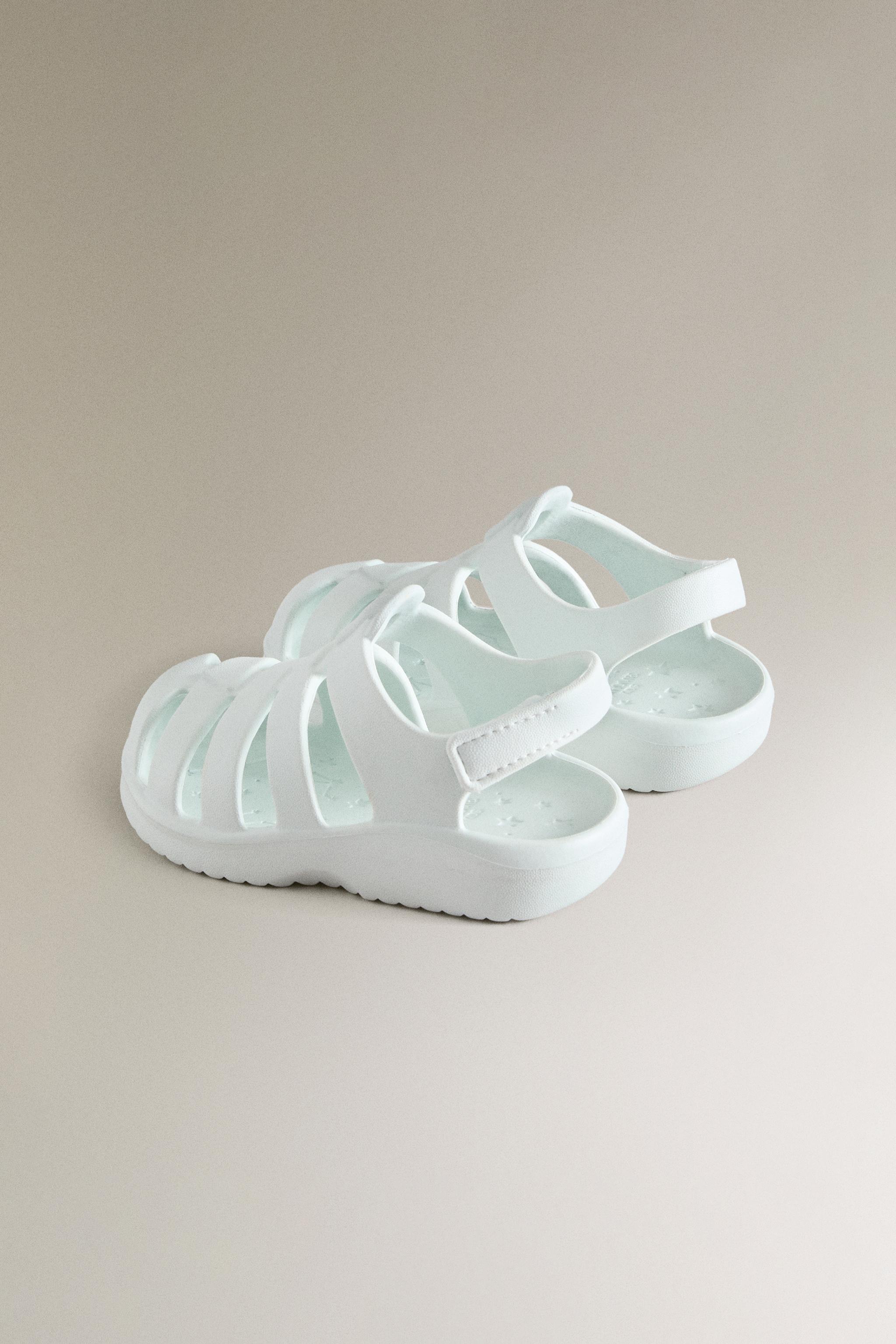 RUBBERIZED CAGE SANDALS WITH AN ADHESIVE STRAP