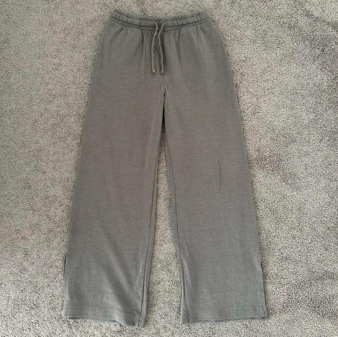 Front view of gray pants with elastic waistband and drawstring.