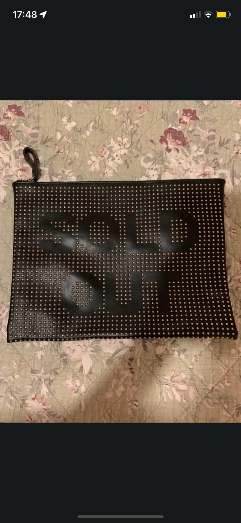 Front view of a black handbag with 'SOLD OUT' text and stud details.