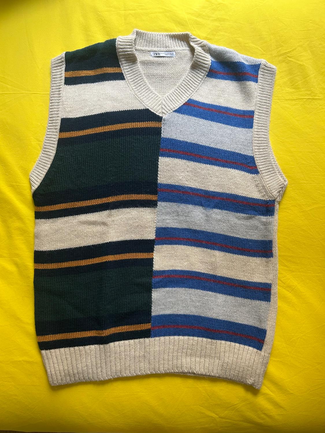 Sleeveless knitted vest with a striped design in shades of blue, green, and beige on a yellow background. Visible label: ZARA.
