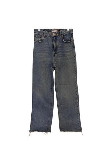 Front view of blue denim jeans with front pockets and a frayed hem.