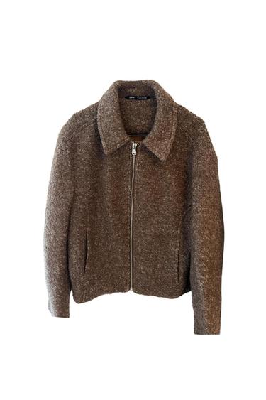 Textured brown jacket with collar, pockets and zip front on a white background. Interior label with the text ZARA.