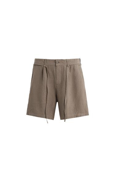 Front view of brown shorts with adjustable belt and front pockets.