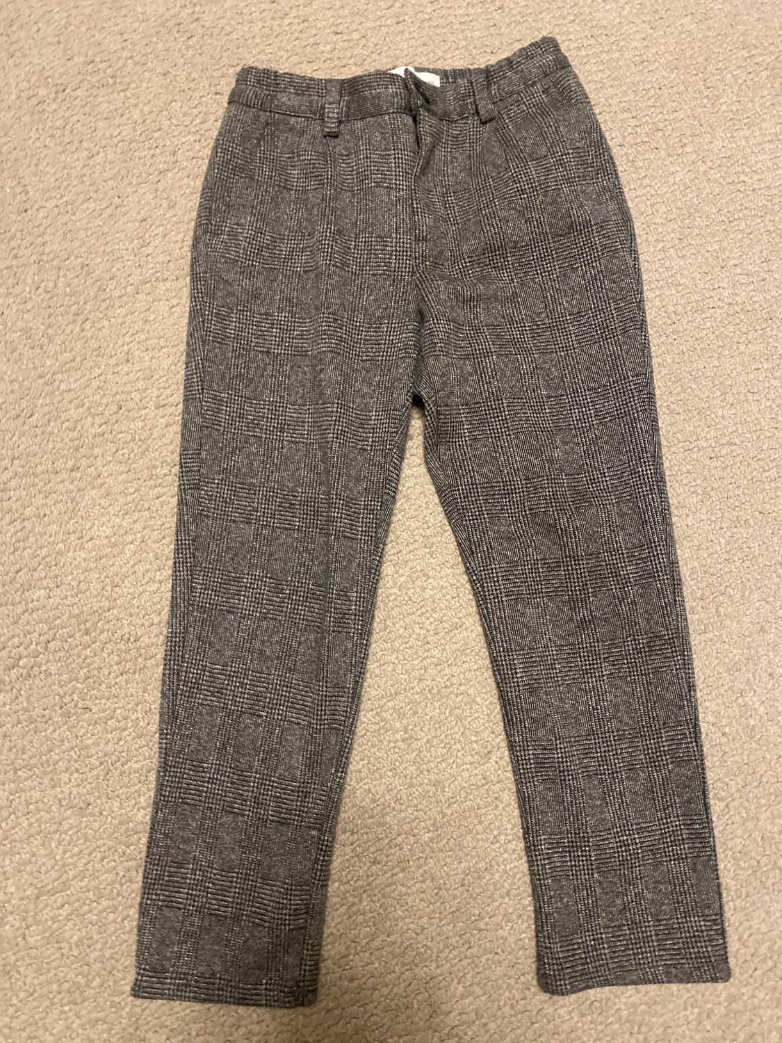 Front view of gray plaid pants with side pockets.