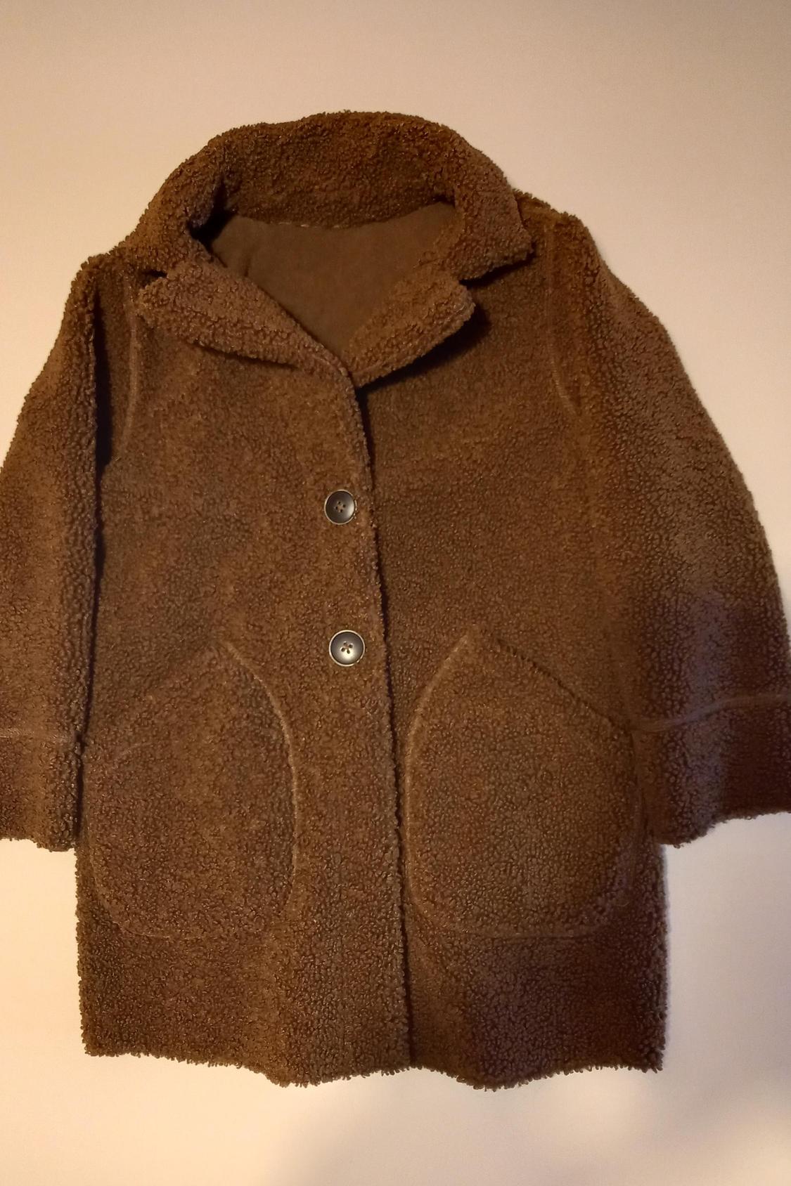 Front view of a brown coat with buttons and front pockets.