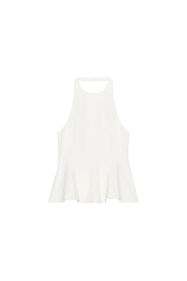 Front view of a sleeveless white blouse with a flared cut and round neck.