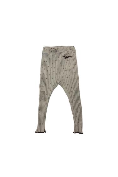 Front view of beige trousers with a polka dot print and a side pocket.