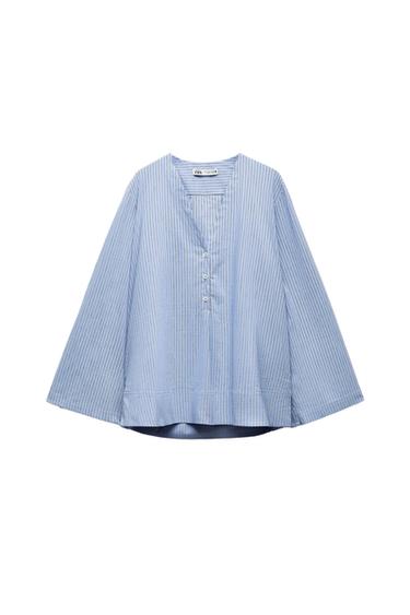 Light blue long-sleeved blouse with vertical stripes, V-neck and front buttons. Label with ZARA text. White background.