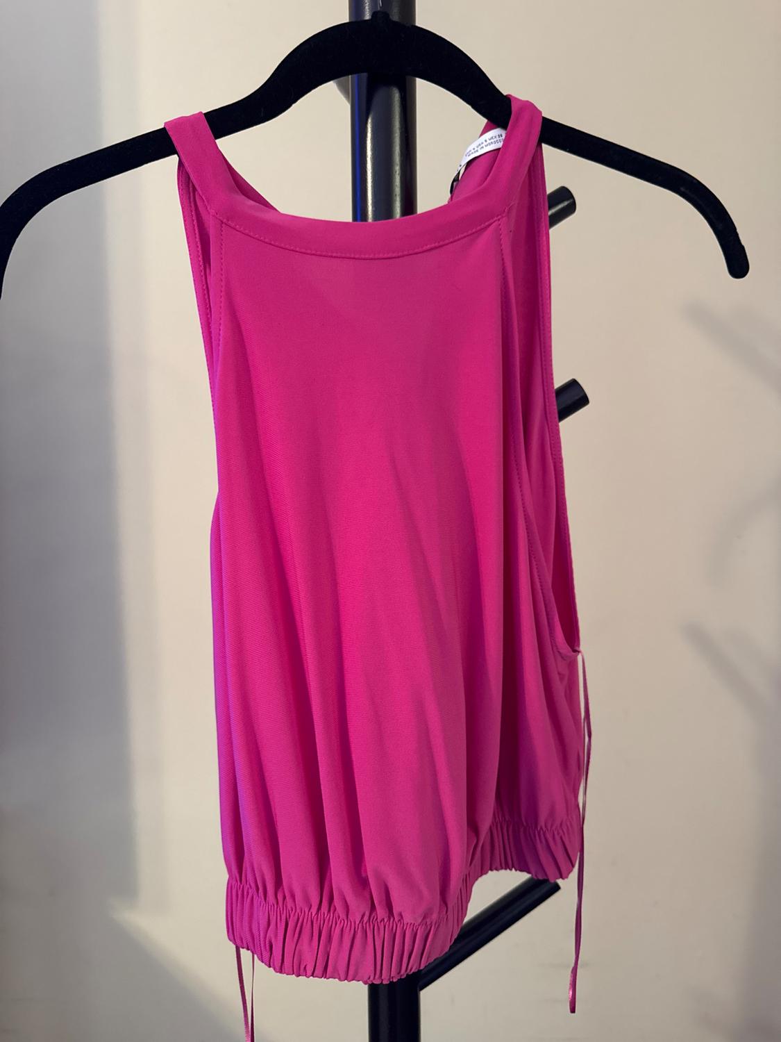 Front view of a fuchsia sleeveless blouse with a round neckline and a gathered hem on a hanger.