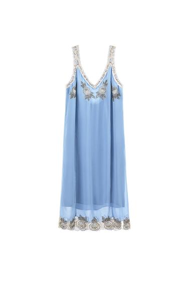 Light blue dress with semi-sheer fabric and a V-neckline. Features floral embroidery on the straps, chest, and hem. White background.
