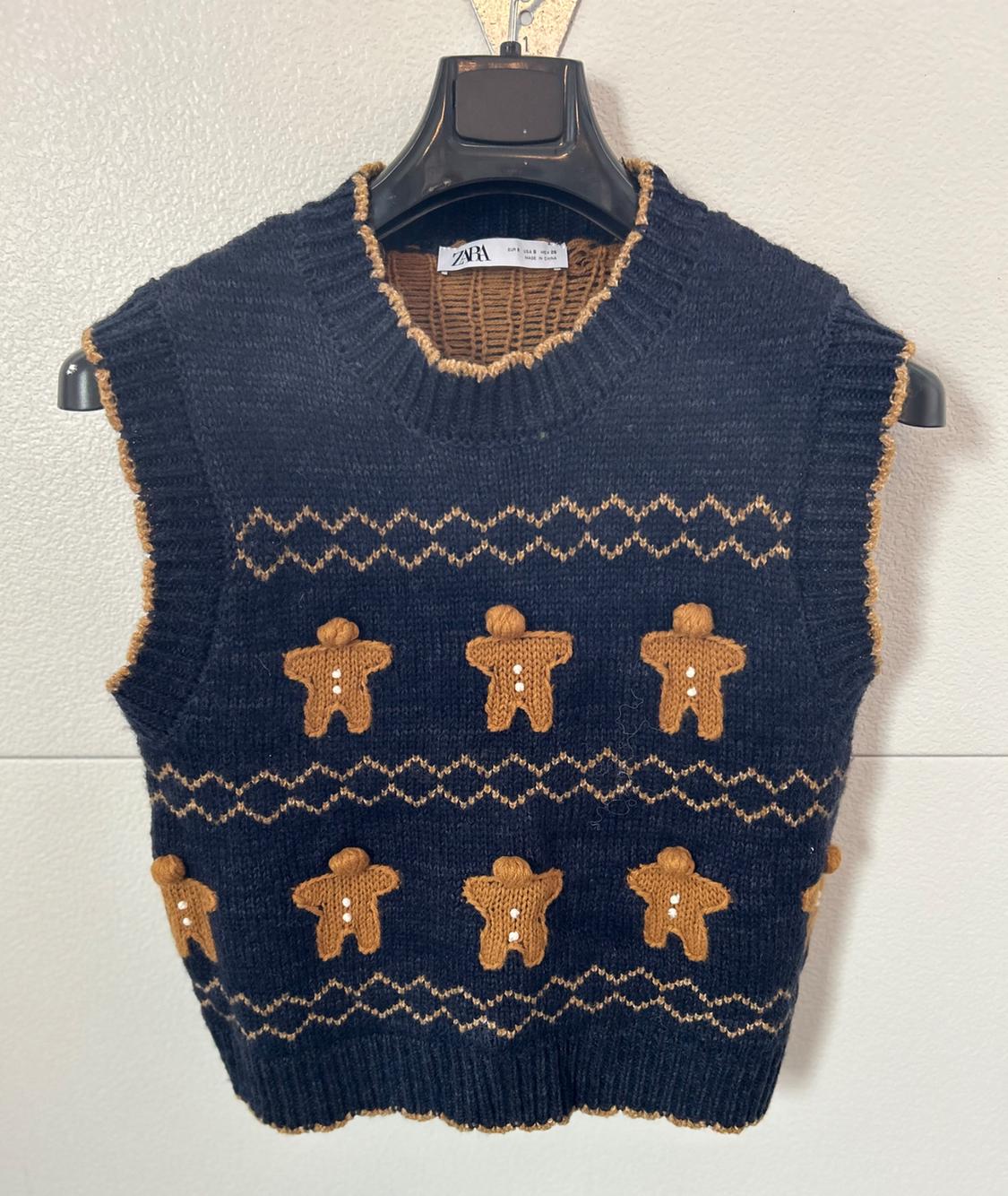 Front view of a black waistcoat with a brown gingerbread man print and a geometric pattern.