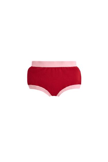 Front view of red shorts with pink waistband and trim.