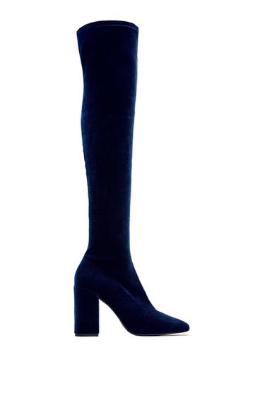 Side view of dark blue high boot with block heel.