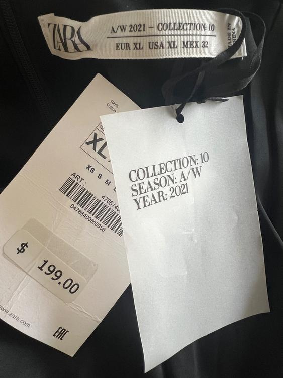 Zara clothing tags with text: "A/W 2021 COLLECTION: 10 SEASON: A/W YEAR: 2021". Price: $199.00. Size: XL. Black background.