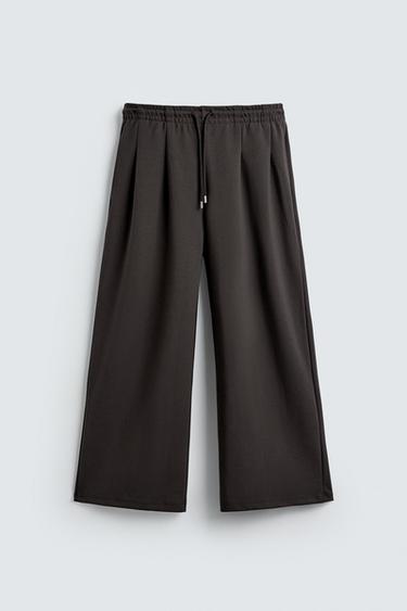 NEOPRENE-EFFECT PLEATED TROUSERS WITH LABEL - Dark brown by Zara