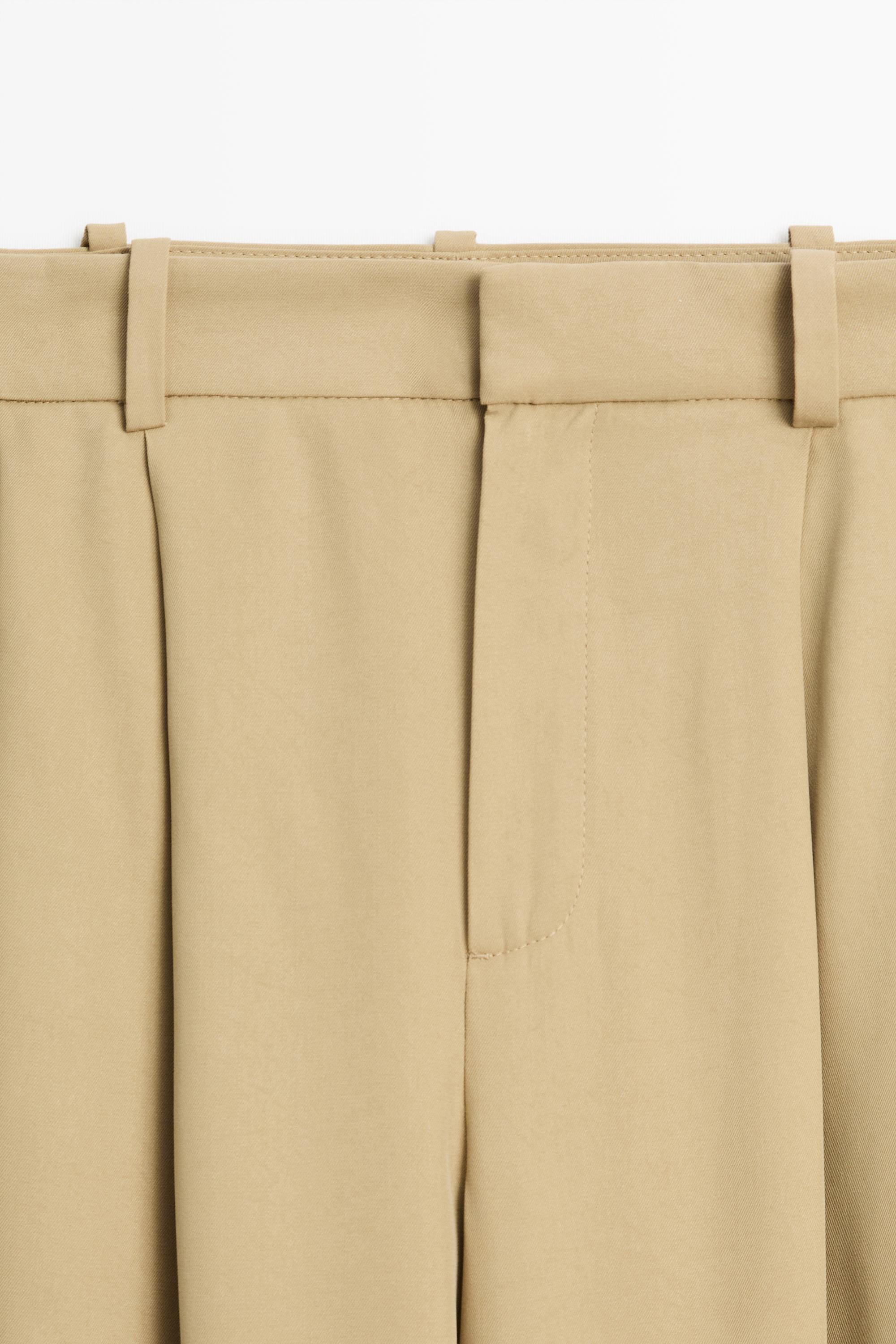 Flowing pleated pants with button detail