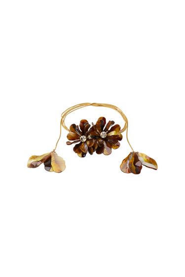 Gold necklace with brown flowers and shiny beads.