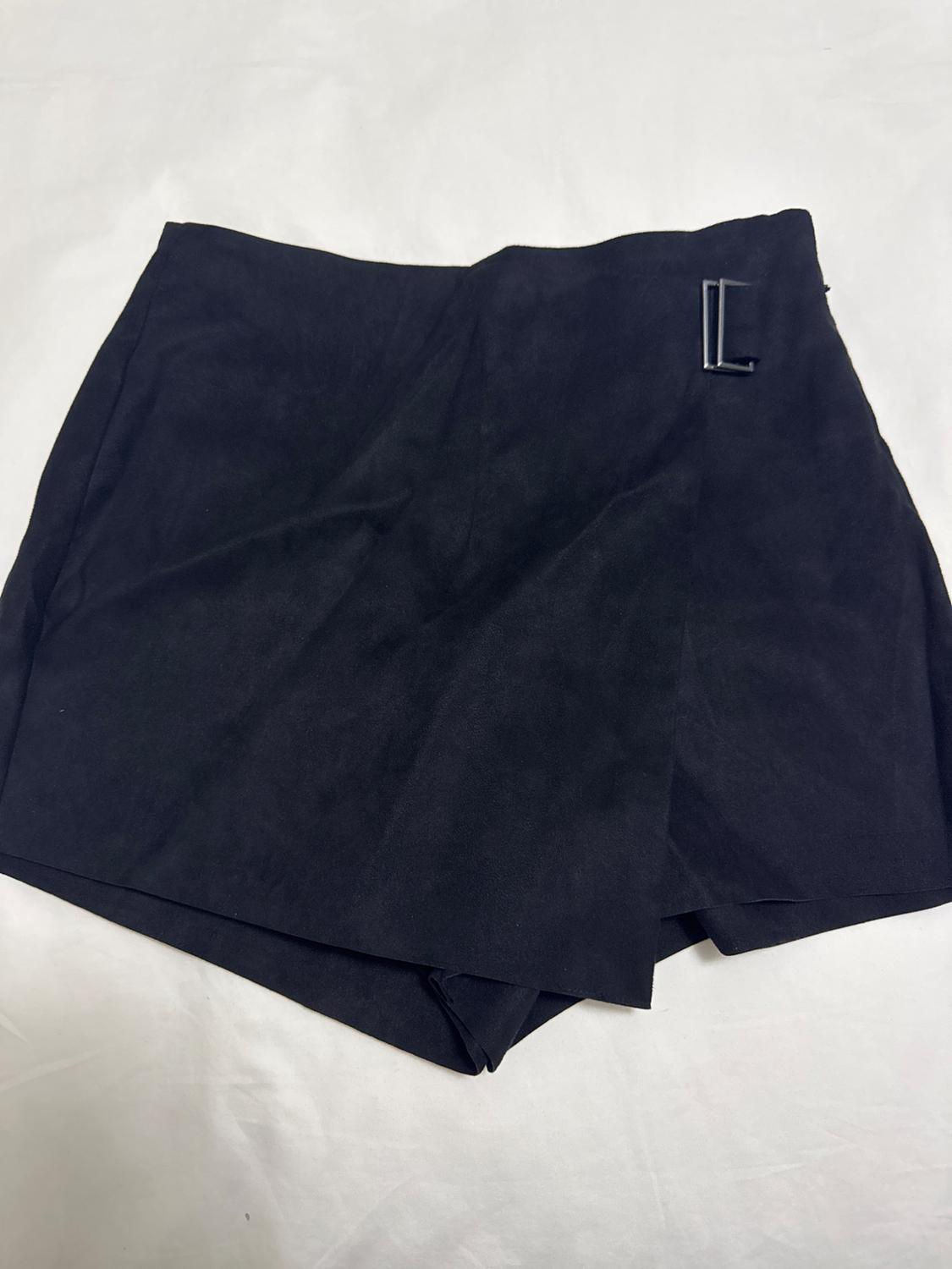 Black mini skirt with crossover design, metal buckle detail on the side, on a white background.