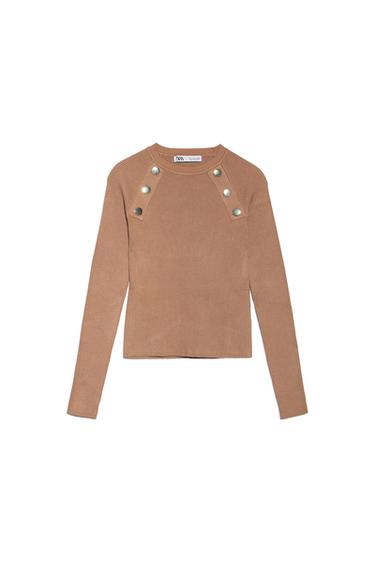 Brown, long-sleeved jumper with decorative buttons on the shoulders. Visible label on the neck with the text "ZARA".