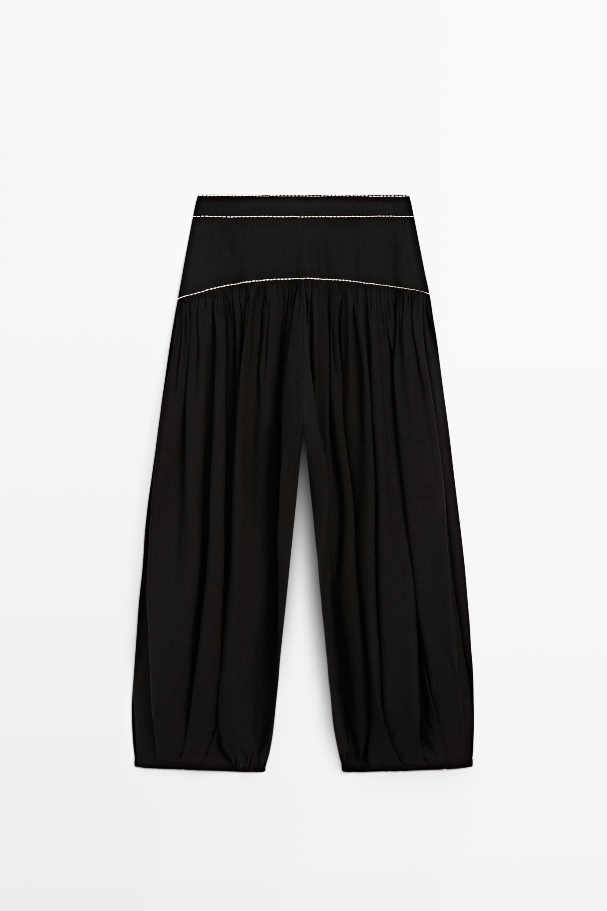 Flowing trousers with contrast detail
