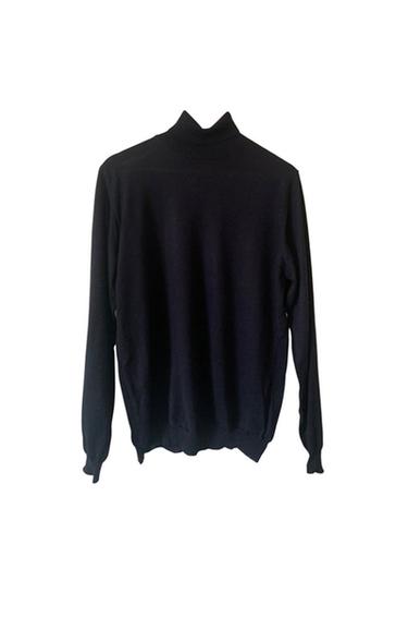 Rear view of a black high-neck, long-sleeved sweater.