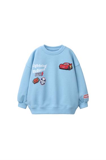 Front view of a mid-blue sweatshirt with a Lightning McQueen print, text "Lightning McQueen", "Lightning Fast", "95", "Piston Cup".