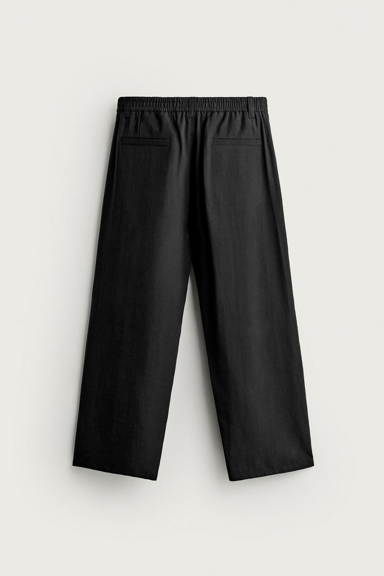 Pantalones fluidos con pliegues laterales 8