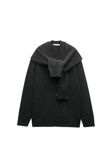 Dark gray cardigan with buttons and a tied sweater over the shoulders. White background. ZARA label on the neck.