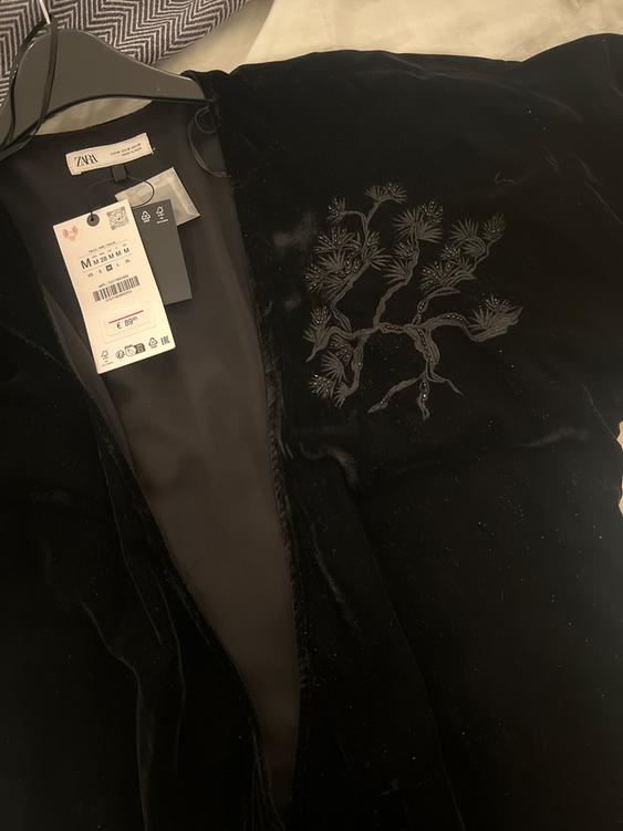 Black velvet jacket with tree embroidery on the chest. Zara tags hanging, visible price: €89.95.