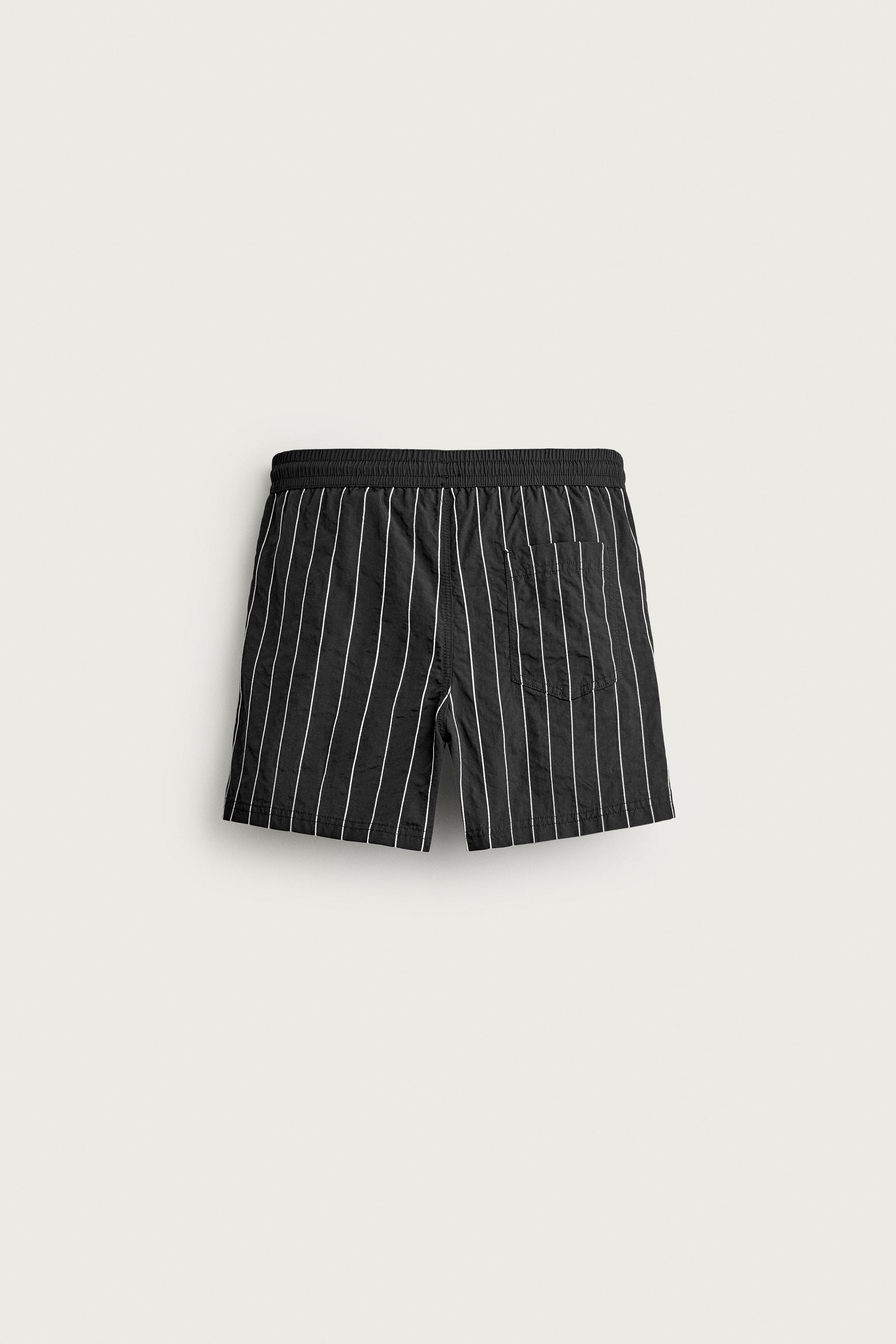 EMBROIDERED STRIPE MID-LENGTH SWIM TRUNKS — Black