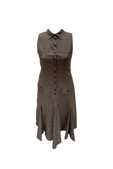 Sleeveless brown shirt dress with front buttons, pockets and a pleated skirt with an asymmetric hem, photographed against a white background.