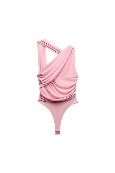 Front view of pink bodysuit with draping and asymmetrical strap.