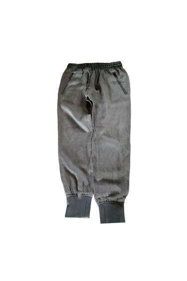 Grey joggers with an elasticated waistband, adjustable drawstring, zip pockets, and ankle cuffs on a white background.