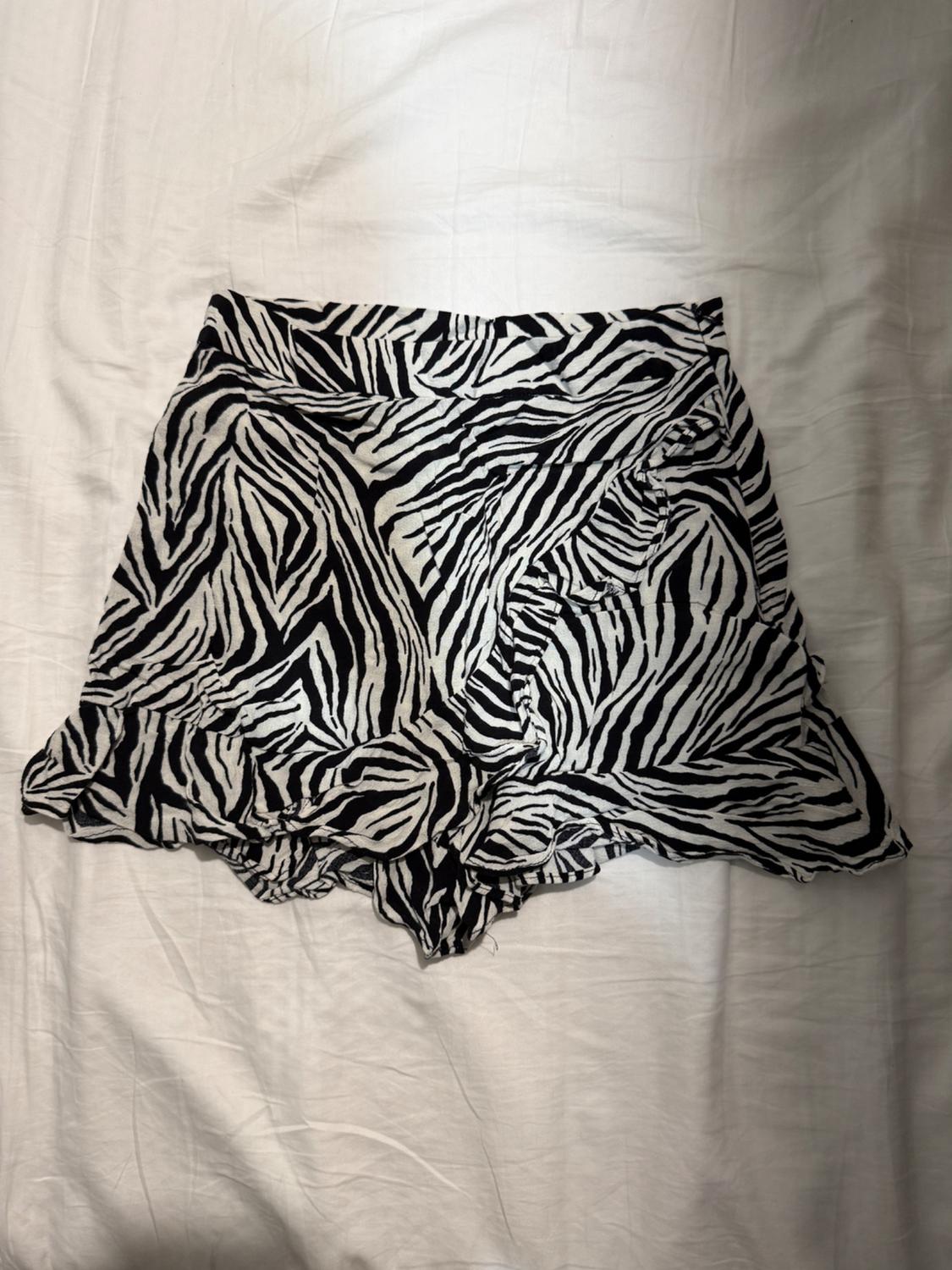 Black and white zebra print shorts on a white surface.